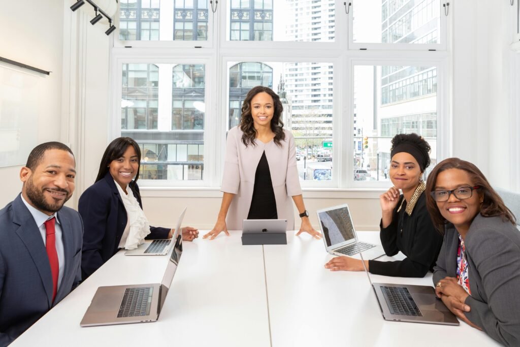 pexels-photo-1367272-1367272 Multicultural team collaborating in boardroom with laptops, showcasing teamwork and diversity.